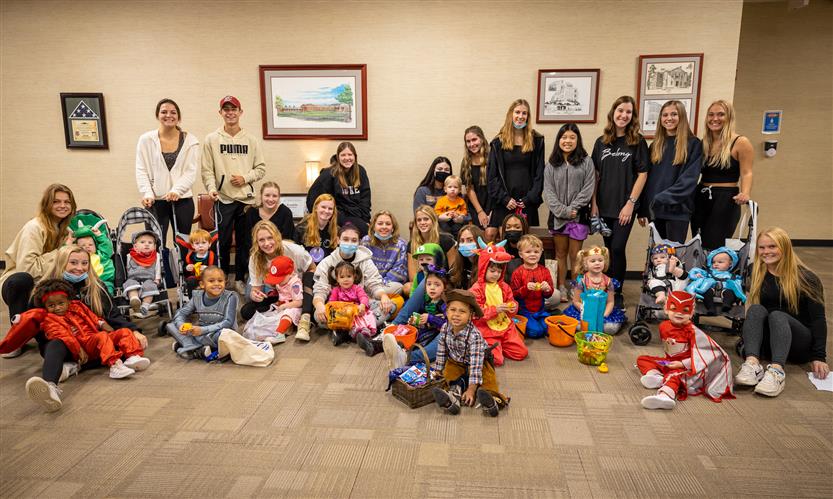 Children in costume trick or treat around school